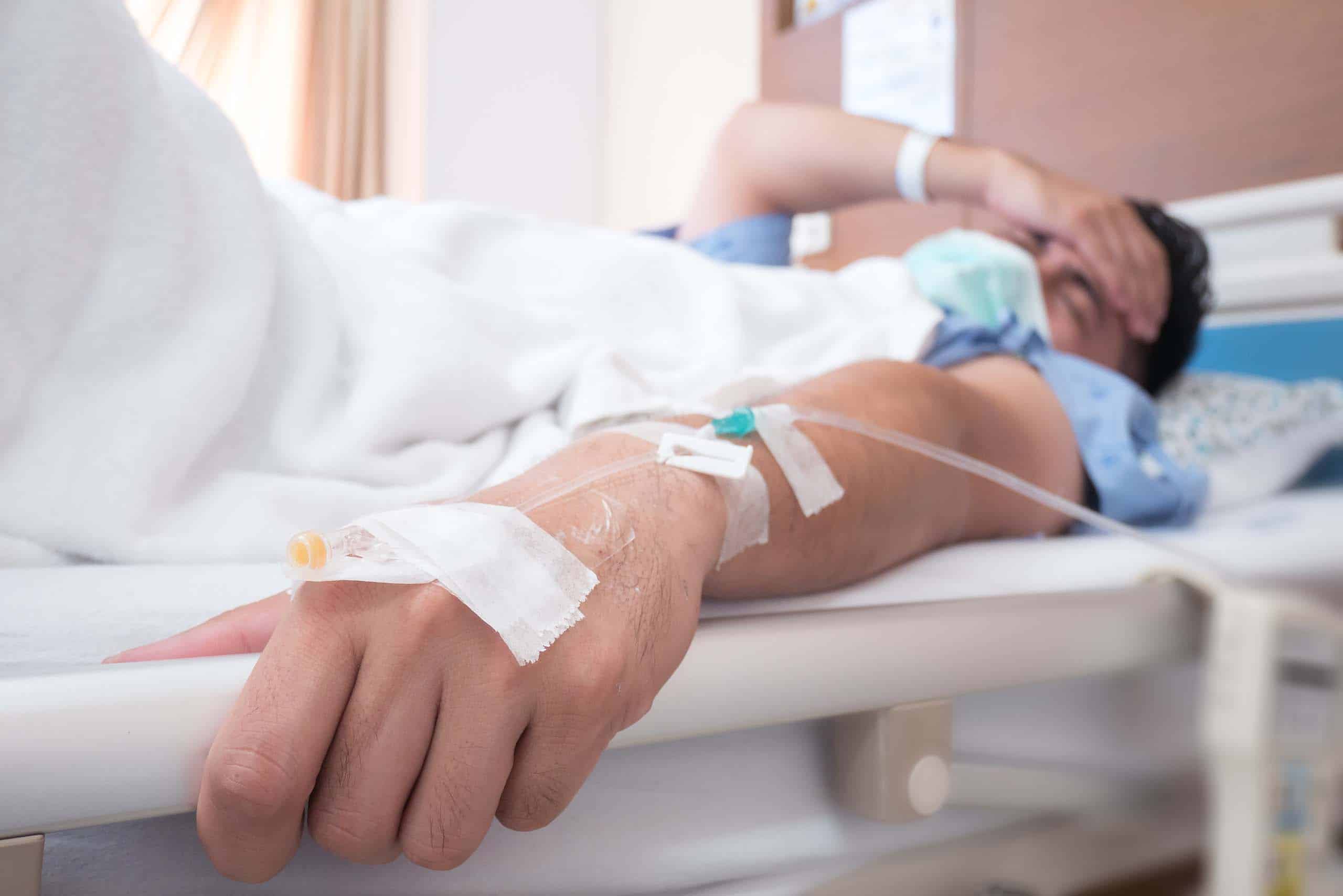 Focus on the hand of a patient on bed in hospital