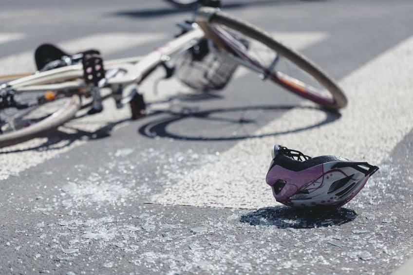 Helmet and bicycle on pedestrian crossing after traffic accident