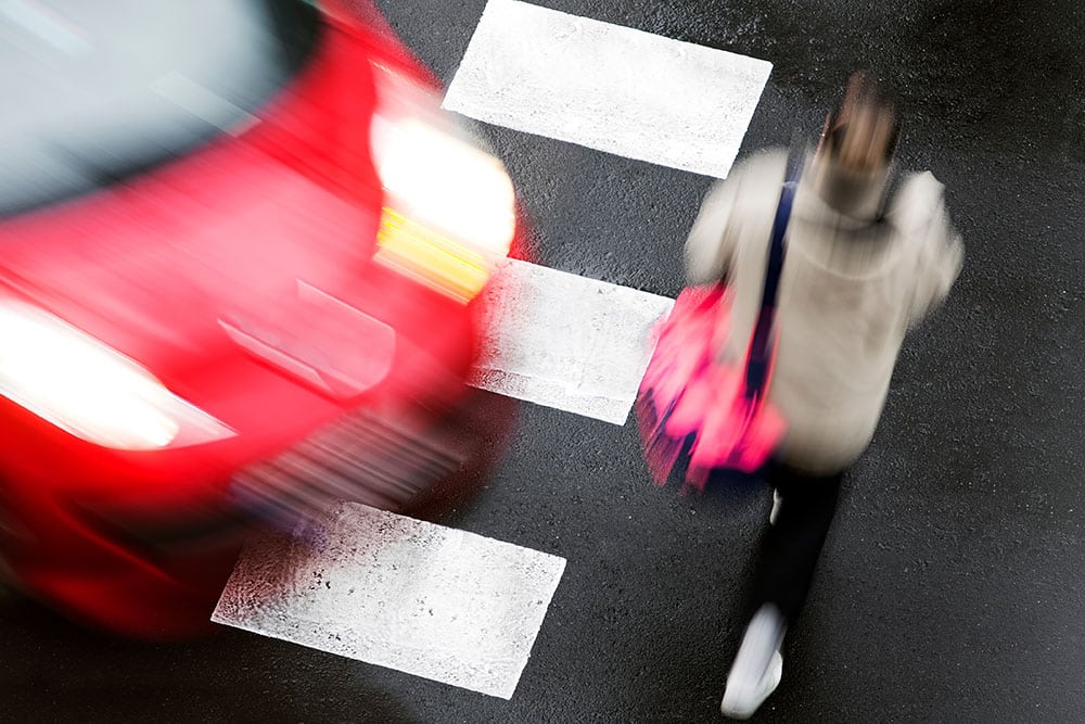Person stepping into path of oncoming car at an intersection in Manhattan New York City