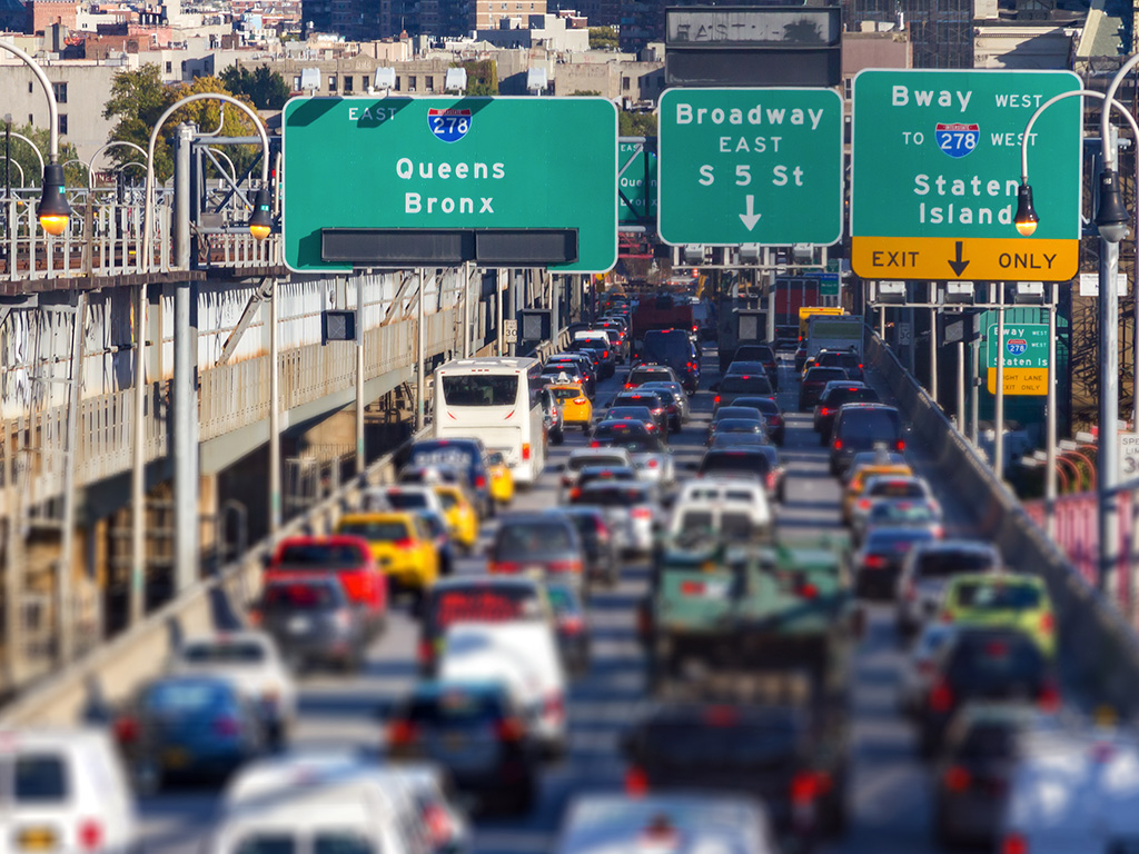 Heavy traffic traveling along a roadway in Brooklyn, New York City.