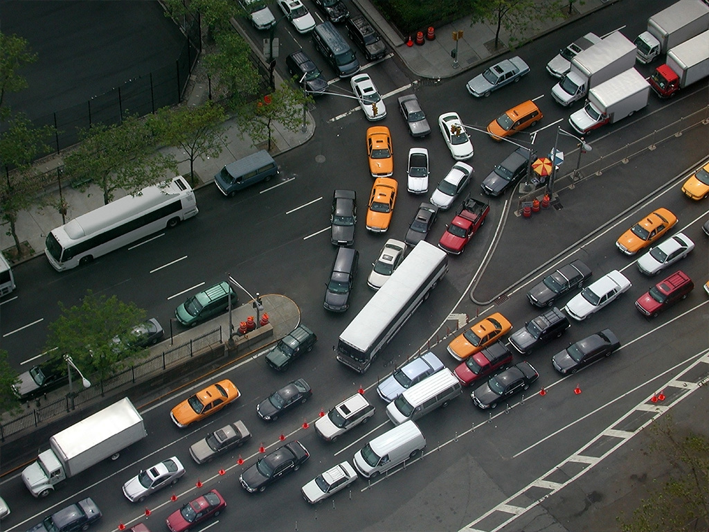 Traffic moving through a major roadway interchange in Manhattan, New York City.