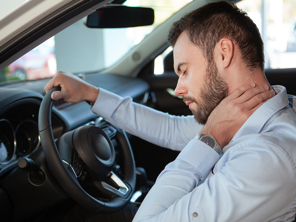 Driver experiencing neck pain and stiffness after a motor vehicle accident.